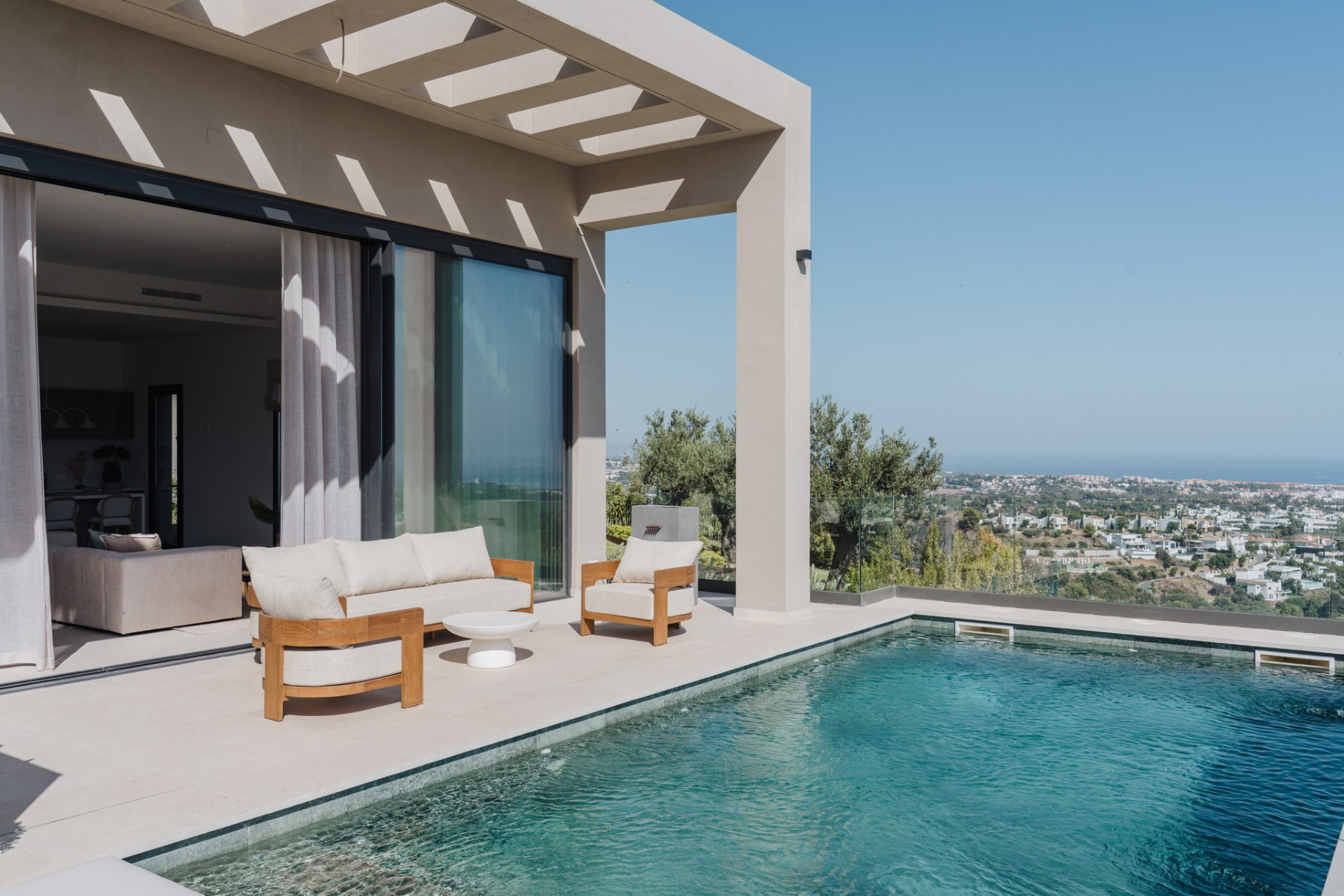 Covered terrace and infinity pool overlooking the coast