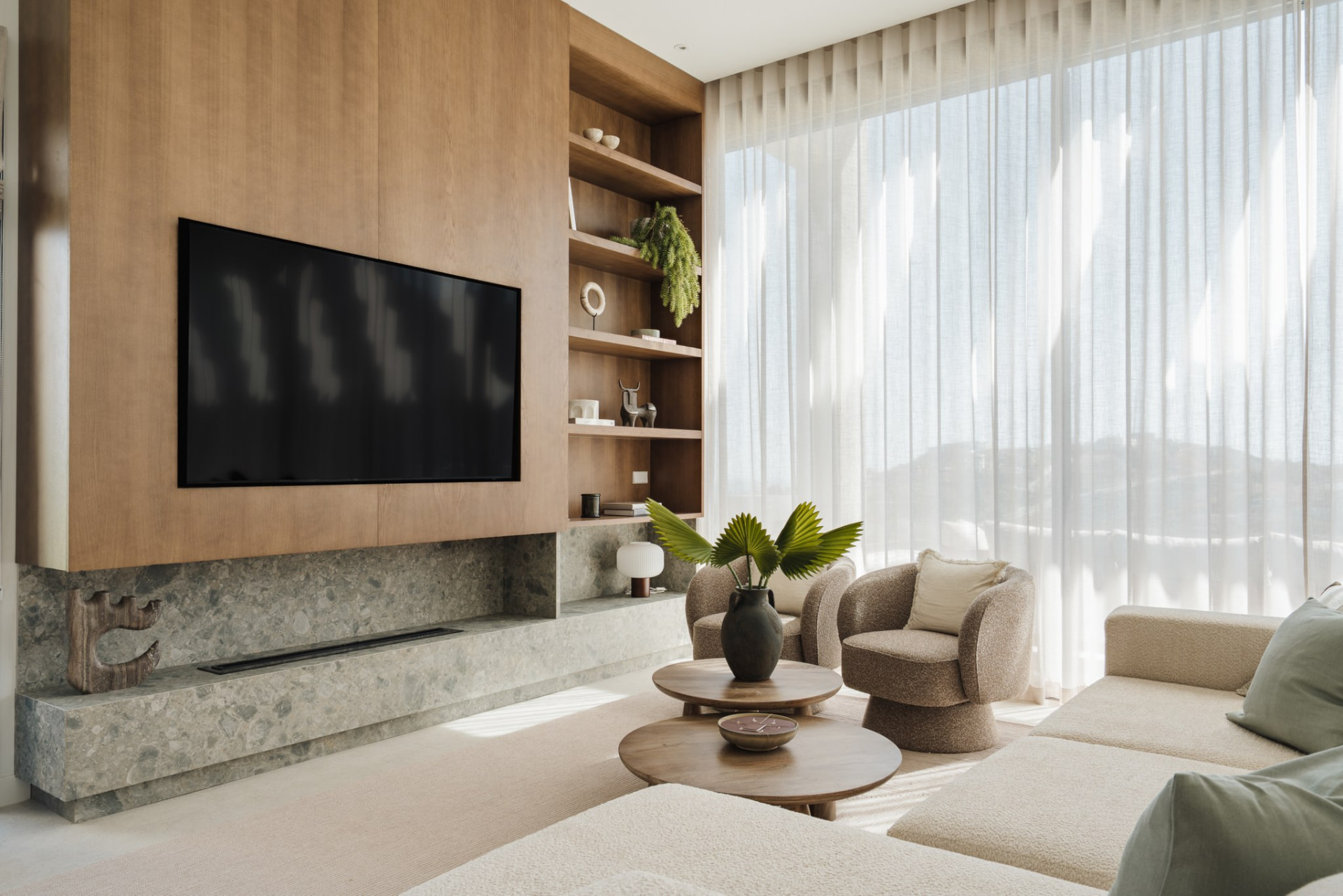 Oak media wall with terrazzo hearth